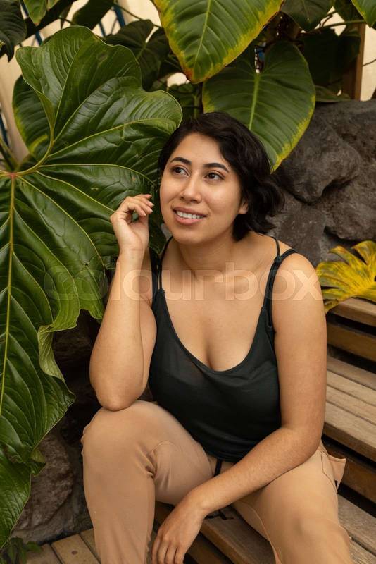 resting sitting on some stairs, young latin woman with short black hair