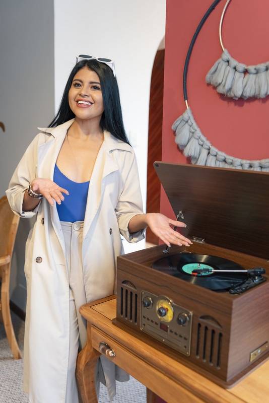 playing music in the interior of the home a young woman with long hair and in casual clothes