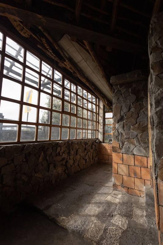 stone corridor with warm natural light filtering through large windows