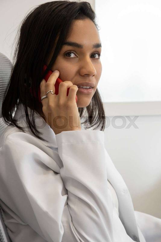 doctor's office, woman at the desk talking on cell phone