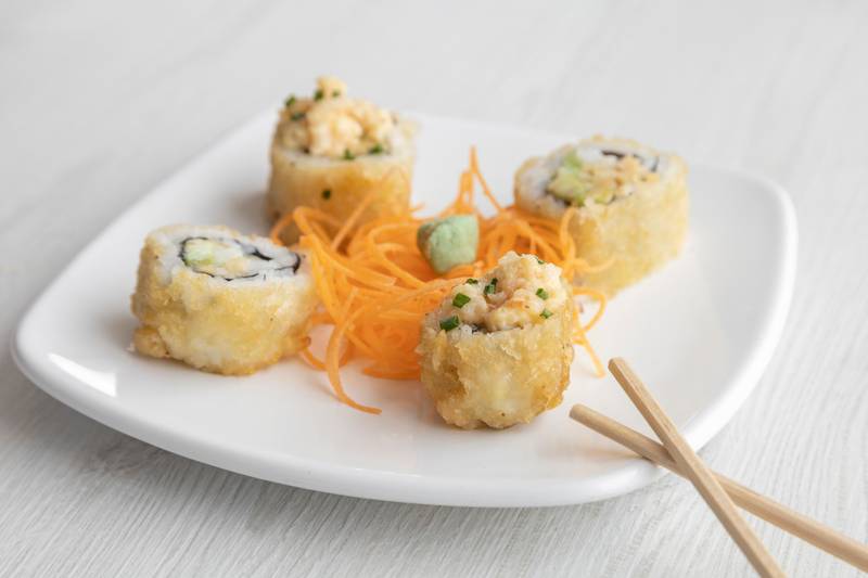 elegant and simple decorated plate with sushi roll, carrot and wasabi, Asian food