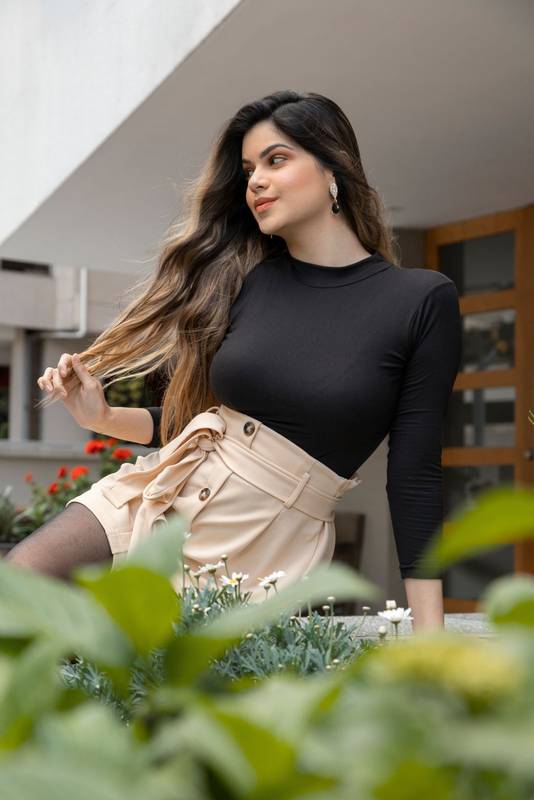 sunny day with a young woman, latina playing with her long blonde hair