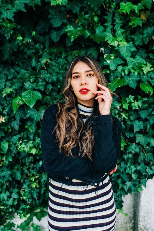 ensual latin young woman with blonde wavy hair