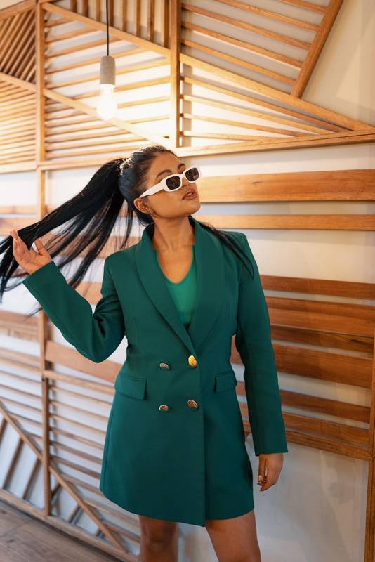 glamorous latin young woman wears a jacket, sunglasses as an accessory