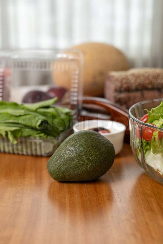 healthy spread featuring various fresh vegetables and a ripe avocado