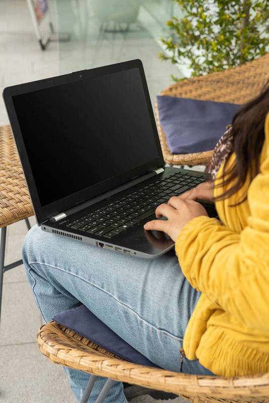 girl turns on her laptop to start studying for her university exam