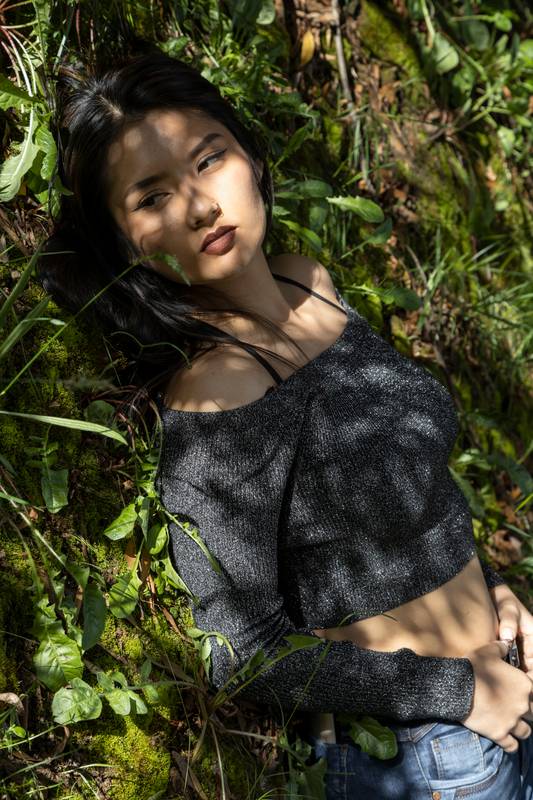 lying down resting on various plants and under the shade of trees on a sunny day beauty of woman