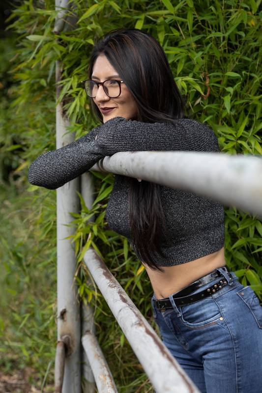 portait of girl railing in the field with plants, summer day