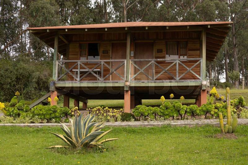 front facade of a cabin with balcony, rustic style