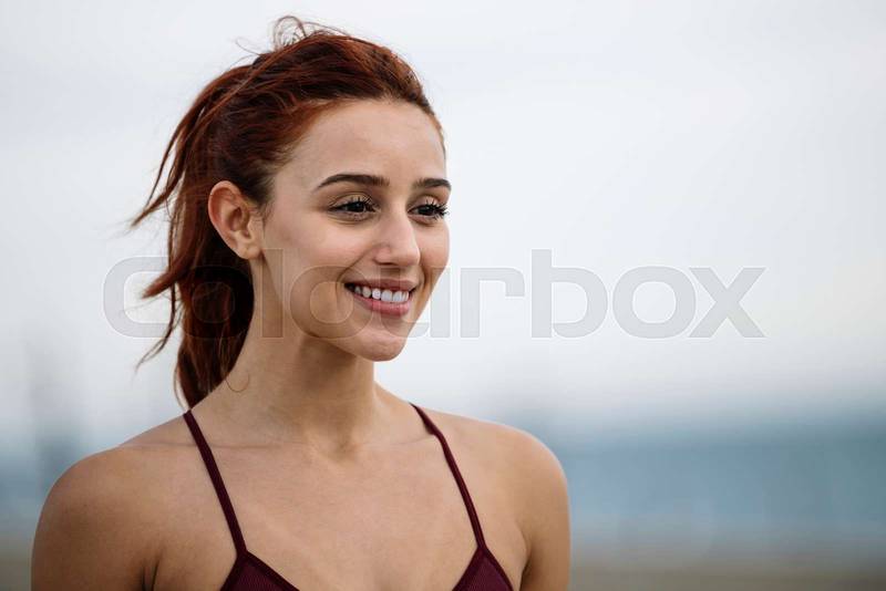 Lovely fit woman joyful close up outside. Sport runner female smiling satisfied in sportswear.