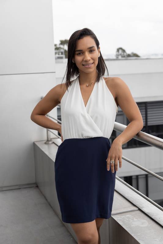 latin woman on a balcony, wears white elegant dress, lifestyle and fashion