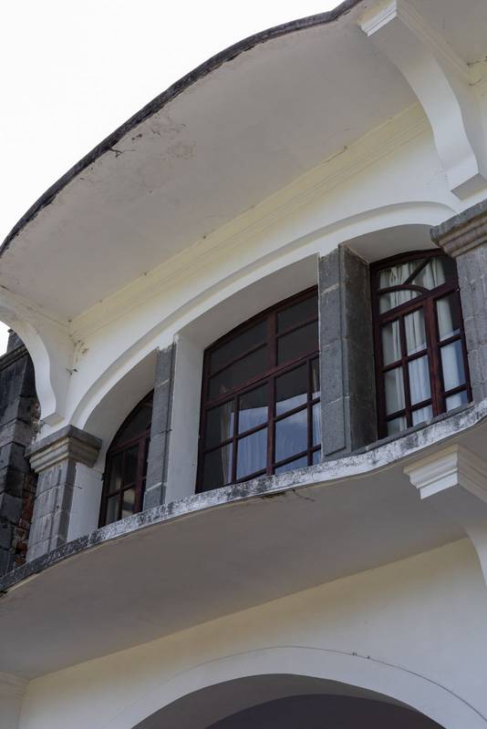 view of a colonial Ecuadorian hacienda window, showcasing rustic textures, elegant design