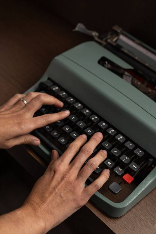 hands typing on a vintage typewriter, capturing the tactile feel of classic writing