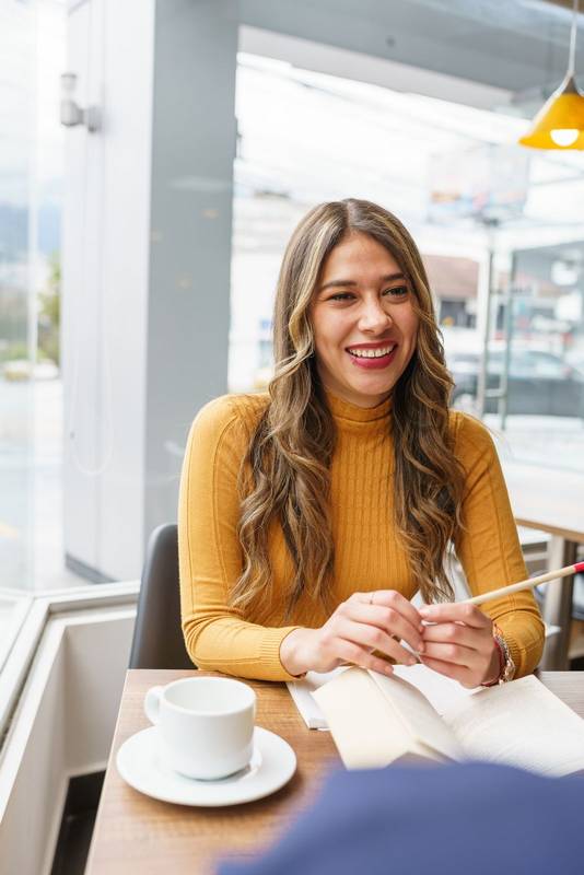 pencil and a cup of hot drink on the table while talking, lifestyle and work