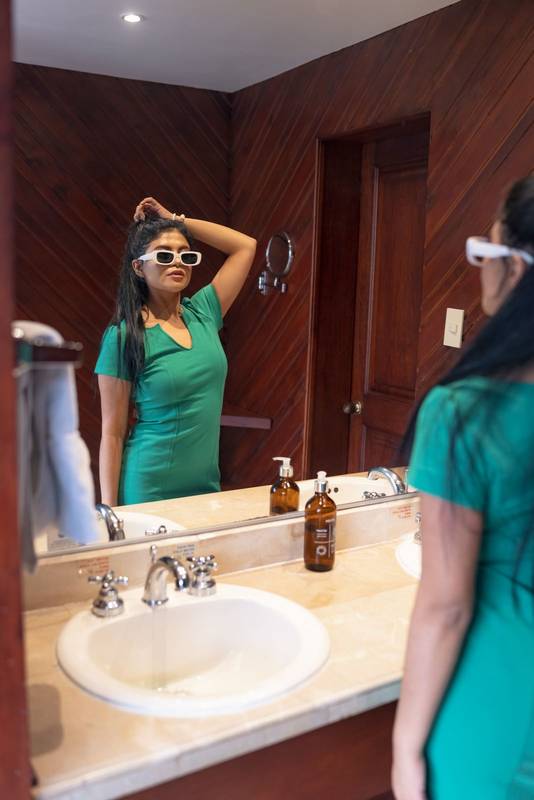 getting ready to go out in bathroom interior young latin woman