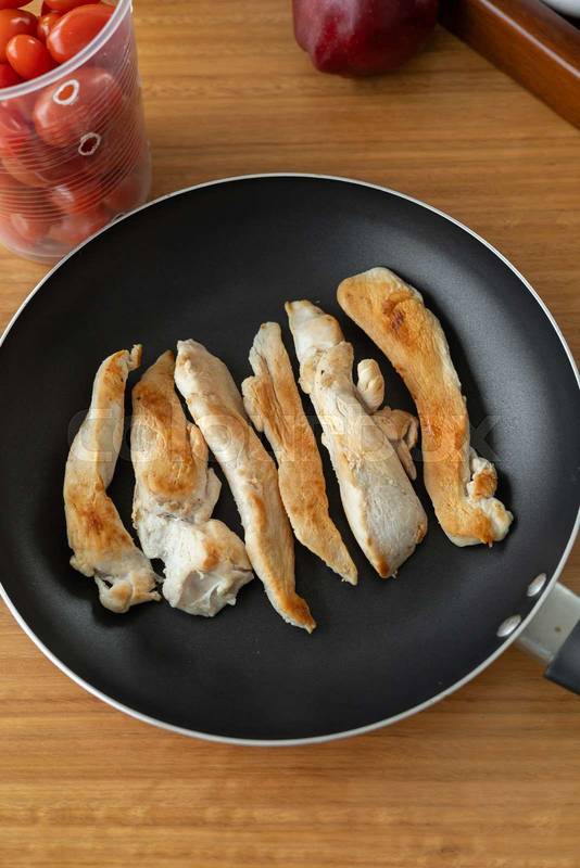 Crispy fried chicken pieces sizzling in a bread, offering a hearty and protein-rich meal