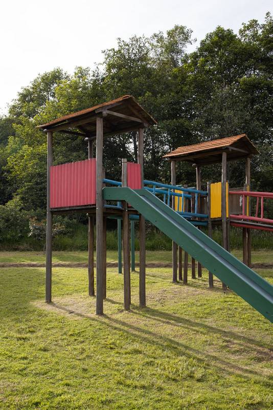sunny day in a park surrounded by nature and wooden playground