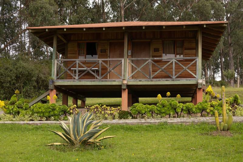 front facade of a cabin with balcony, rustic style