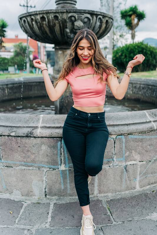 standing attractive young latin woman enjoying the day