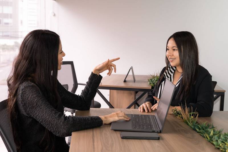 boss firmly addresses her subordinate about a work error in a modern office setting