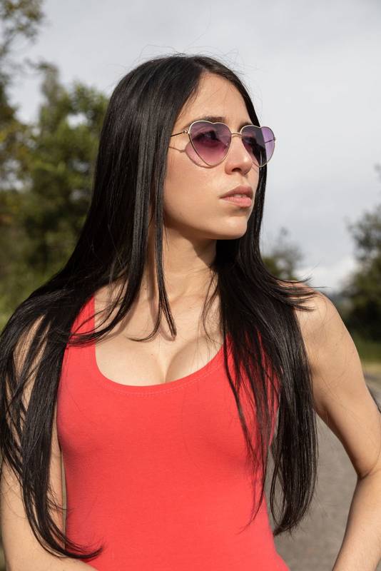 face of an attractive latin young woman with long, straight black hair, wears a red dress, natural makeup