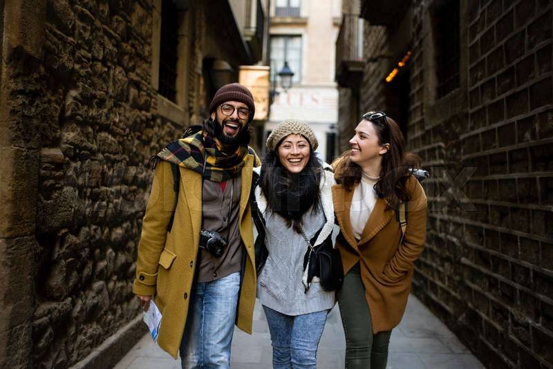 Cheerful multi-ethinc group of friends tourists having fun and walking on the streets of Barcelona - Travel, holidays and friendship concept