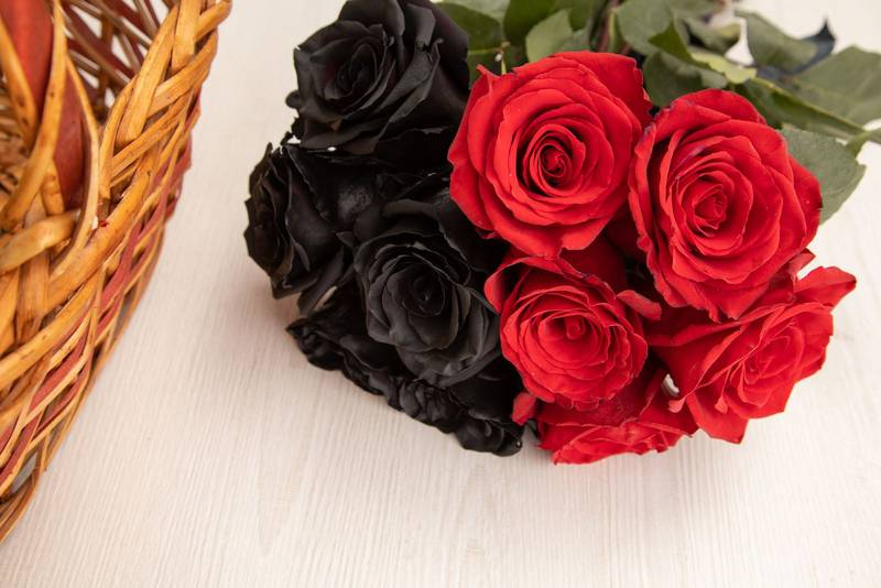 black and red flowers, next to a basket, beautiful romantic decoration with beauty of nature