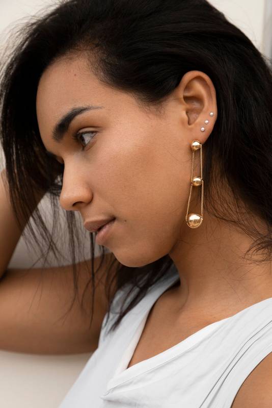 natural beauty in studio with long earrings, model