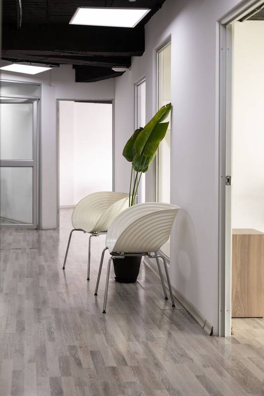 clean hallway with elegant white chairs, perfect for a medical or dental office waiting area
