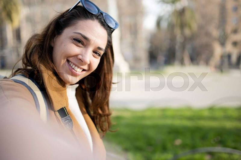 happy young woman tourist walking on the city and looking back - pov cheerful couple on holidays - travel, relaxation, friendship concept