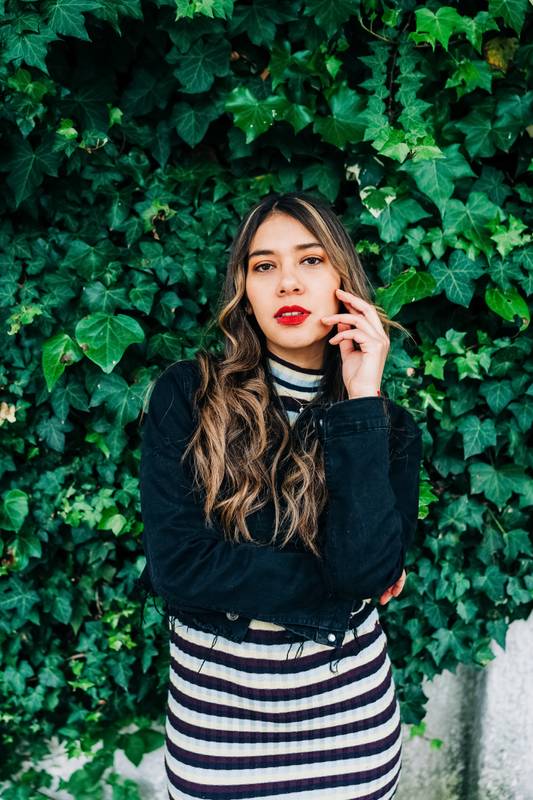 ensual latin young woman with blonde wavy hair