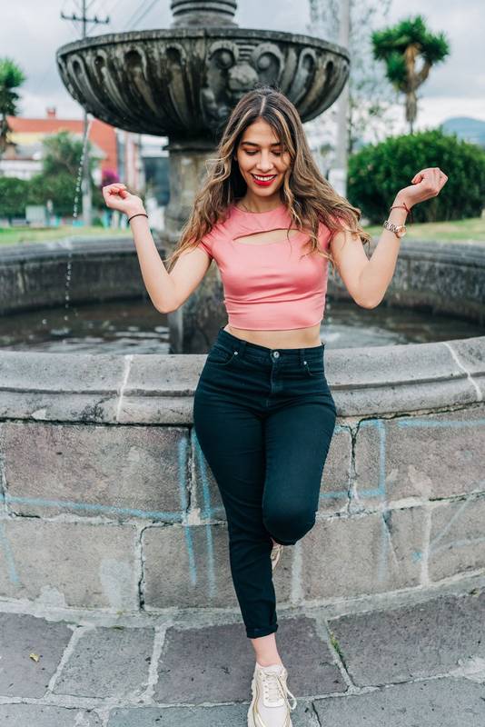 standing attractive young latin woman enjoying the day