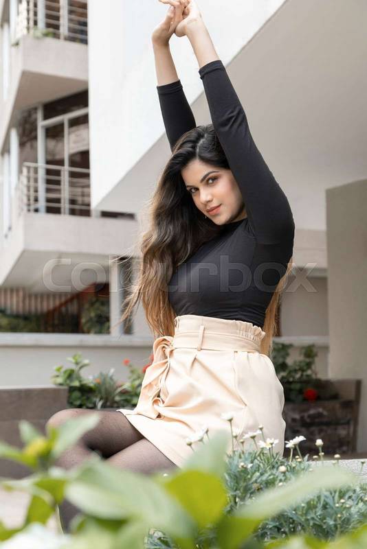 arms raised, wears fashionable clothes, beauty in the city, beautiful girl