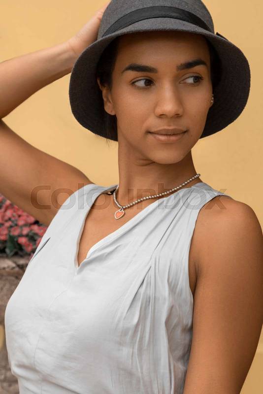 woman wearing a hat and white casual jumpsuit, fashion and beauty