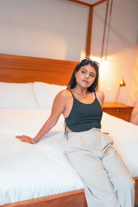 room interior sitting on the edge of a bed a young woman