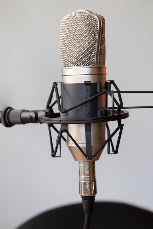 professional microphone with a stand and cable, musical instrument in studio