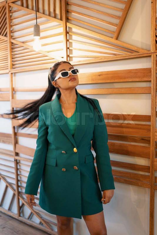 latin woman wears a stylish jacket, sunglasses as an accessory, lifestyle, fashion
