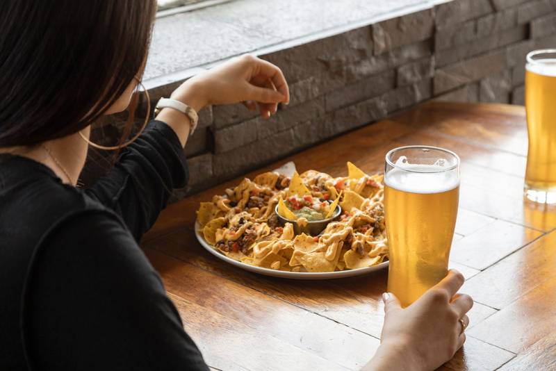eating snacks with a drink, at a restaurant table, food