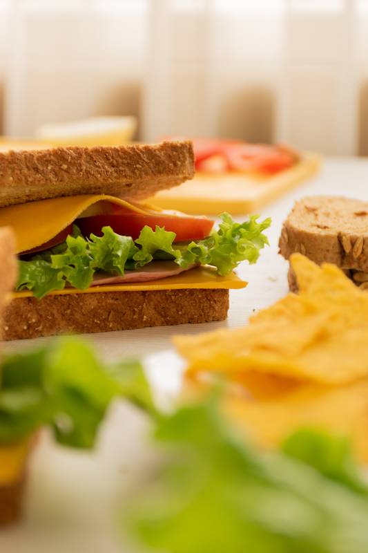 plate with nachos on a table, delicious sandwiches prepared with fresh ingredients