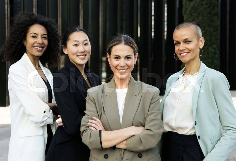 Multiracial group of successful confident women office corporate professional experts. Female team smiling looking at camera. Business concept