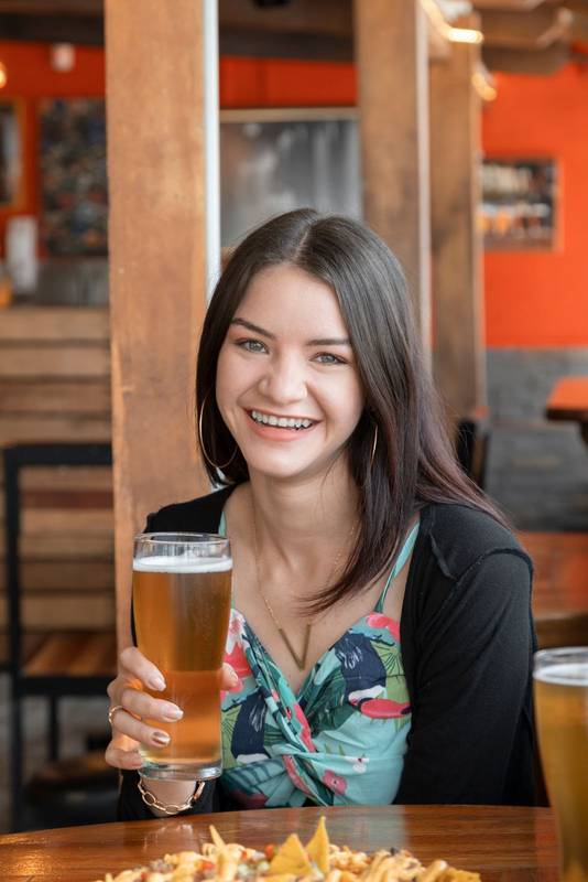 woman with long hair having fun in a restaurant with wooden furniture