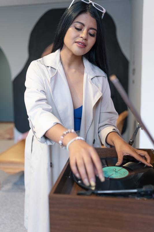 dj preparing a party, putting on music a young woman