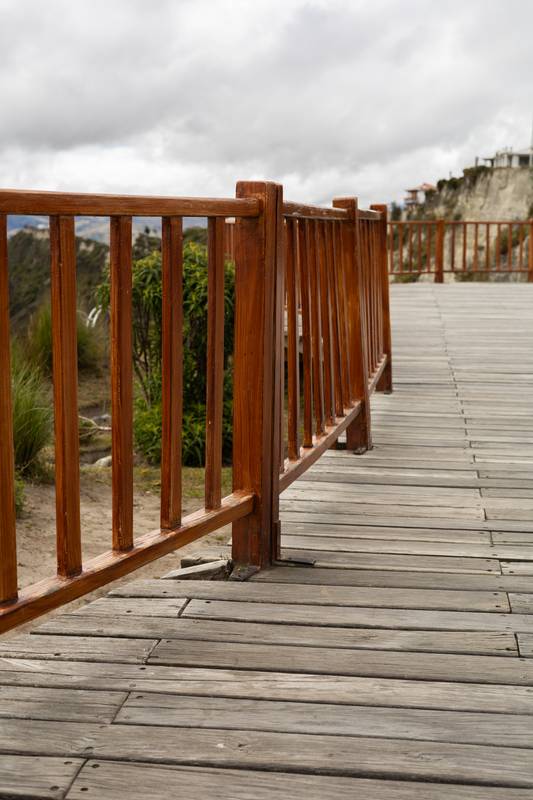 rustic wooden viewpoint overlooks the breathtaking Quilotoa Lake nestled in Ecuador’s mountains