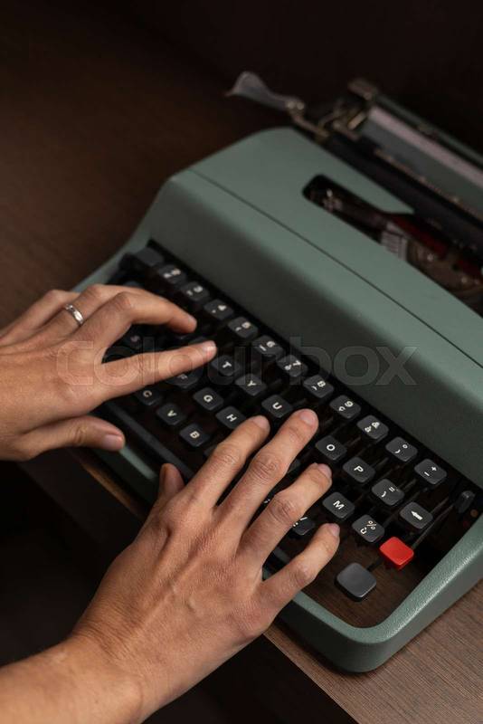 hands typing on a vintage typewriter, capturing the tactile feel of classic writing