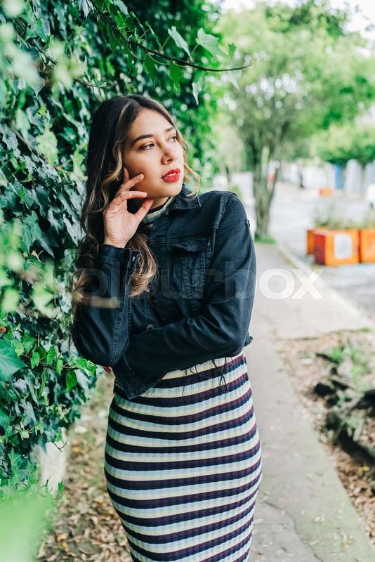 latin woman with long blonde hair, wearing long casual dress with a jacket, fashion