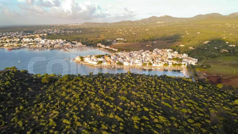 drone aerial view of the mediterranean sea at sunrise of small fishing port and marina, in portocolom,mallorca,balearic islands